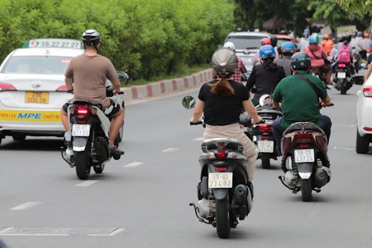 Motorbikes and traffic on a busy Vietnamese road, showcasing local transportation culture.