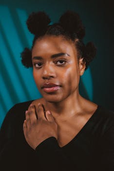 Elegant portrait of a black woman in studio setting showcasing natural hairstyle and poise.
